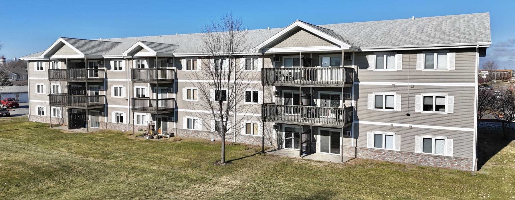 a large building with a lawn in front of it