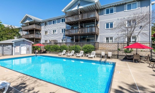 Resort-style swimming pool with lounge seating